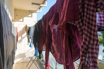 Clothes dry by hanging on clothes line at the balcony