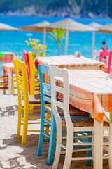 Color Chairs in restaurant on sea coast in Greece
