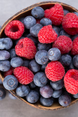 Juicy and fresh blueberries with green mint on rustic gray table.