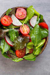 Fresh salad with baby spinach and tomatoes, radish und salad.