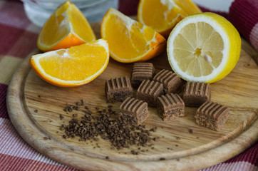 Wooden dish with lemon, orange, coffee grain and toffee