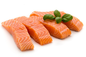 Fresh salmon fillet with basil on the white background.