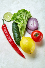 Fresh vegetables still life. Veges lined up on a white background, top view, close-up, selective focus, copy space.