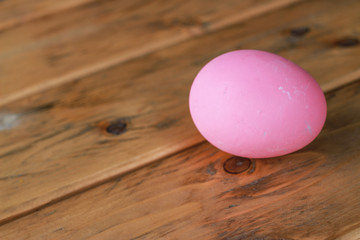 pink easter egg on wooden table 