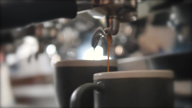 Fresh Black Coffee Pouring from Professional Machine Dispenser in Cups. 4K, Macro Slowmotion.