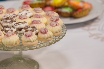 sweet cakes with icing on a platter.