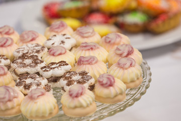 sweet cakes with icing on a platter.