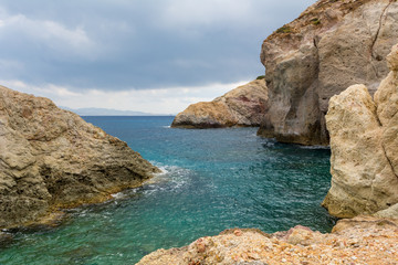 Fototapeta na wymiar Rocks and emerald sea water in Firopotamos Bay on Milos, Cyclades Islands, Greece.