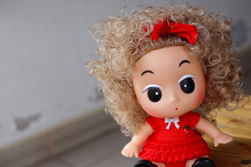 Toy doll baby girl seating on ground 