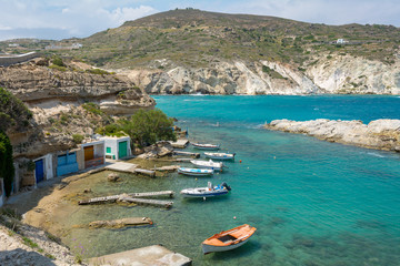 Traditional Greek boats moored in Mandrakia village. Milos Island, Greece.