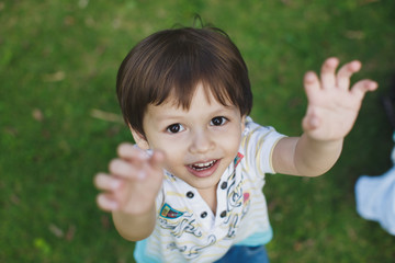 boy stretches his hands to his father