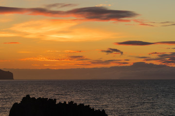The Atlantic Ocean at dawn under the beautiful colorful sky with interesting clouds just before sunrise
