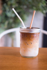Iced coffee in glass on table in cafe