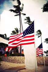 Two American flags on the beach. Independence day