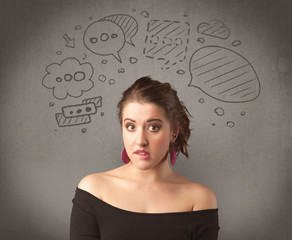 A cute female student making funny expressions with thoughts in her head illustrated by drawn chat bubbles on the urban wall background concept.