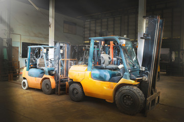The two yellow forklift in the big warehouse 