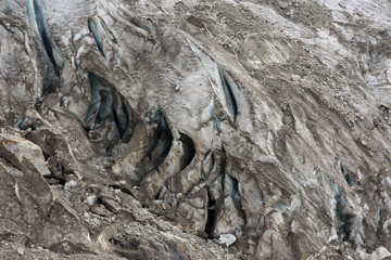 Aerial view of show and ice of Kashkatash Glacier on the west Caucasian mountains in Russia.