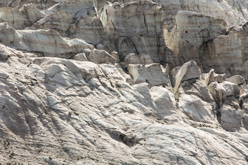 Aerial view of show and ice of Kashkatash Glacier on the west Caucasian mountains in Russia.