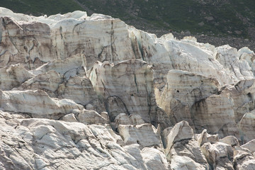 Aerial view of show and ice of Kashkatash Glacier on the west Caucasian mountains in Russia.