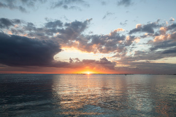 Aerial panoramic view of sunset over ocean.