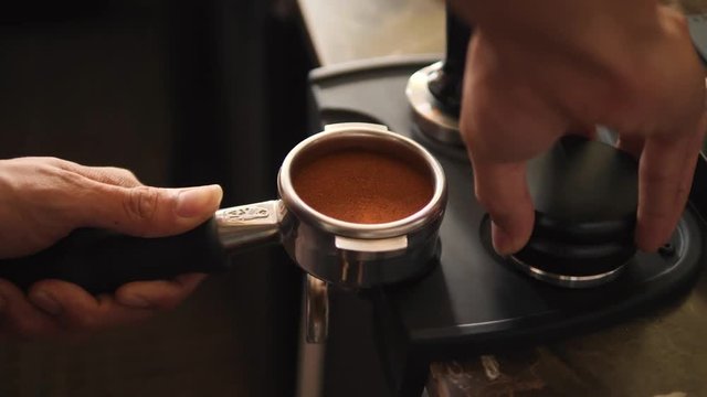 Barista Pressing Down Coffee Beans. Process of Making Fresh Coffee on Professional Machine. 4K, Slowmotion.