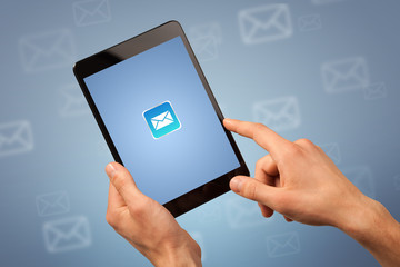 Female fingers touching tablet with mail icon on it 