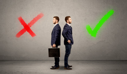 Young conflicted businessman choosing between a right and a wrong direction