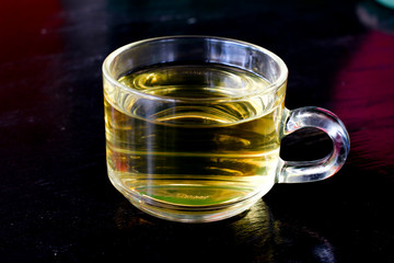 Tea on black wooden background 