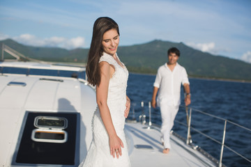 Just married couple on yacht. Happy bride and groom