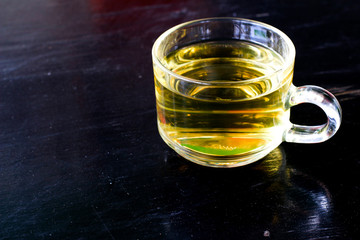 Tea on black wooden background 
