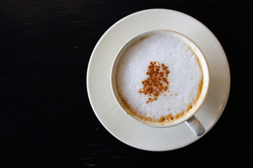Hot Cappuccino  on black background 