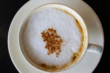 Hot Cappuccino  on black background 