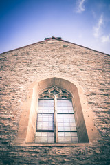 Decorative gothic window of a medieval stone cathedral
