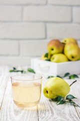 Glass of pear compote on light wooden background. Selective focus, space for text. 