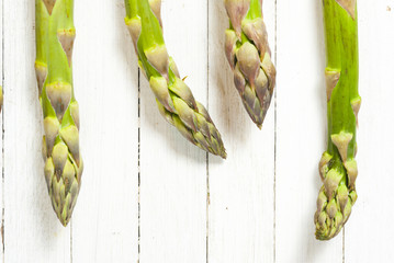 Green asparagus on white wood table