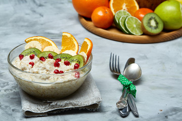 Breakfast still life with oatmeal porridge and fruits, top view, selective focus, shallow depth of field.