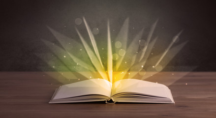 Yellow lights spreading from an open book 
