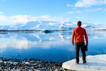 adventurer resting at jokulsarlon glacier, iceland