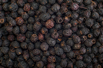 Texture of dried black berries, food background