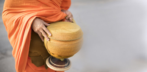 The Thailand monk holding aim bowl.merit to the morning days of Buddhist monks.