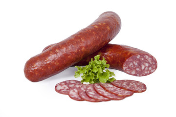 Semi-dry sausage with pieces of fat in natural shell. Isolated on white background