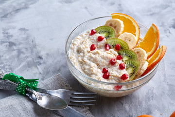Breakfast still life with oatmeal porridge and fruits, top view, selective focus, shallow depth of field.