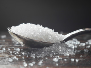 Sugar on a spoon close-up, macro photo.