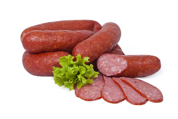 Smoked sausage decorated with leaf of lettuce. Isolated on white background
