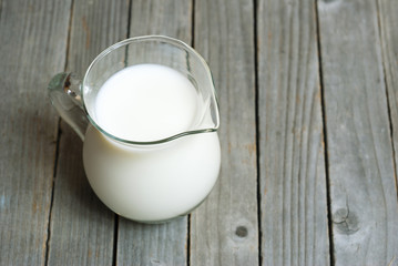 Milk jug on old wooden table