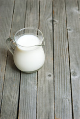 Milk jug on old wooden table