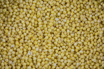 The millet seeds` texture or background. The macro shot is made by means of stacking technology