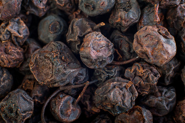 Texture of dried black berries, food background