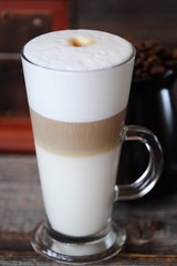 Delicious fresh latte coffee on wooden table 