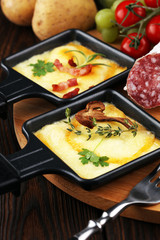 Delicious traditional Swiss melted raclette cheese on diced boiled or baked potato.